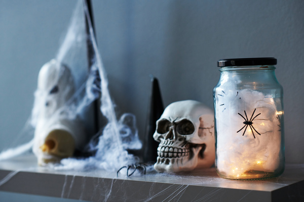 Can of Spiders and Other Halloween Paraphernalia Decorate Shelf